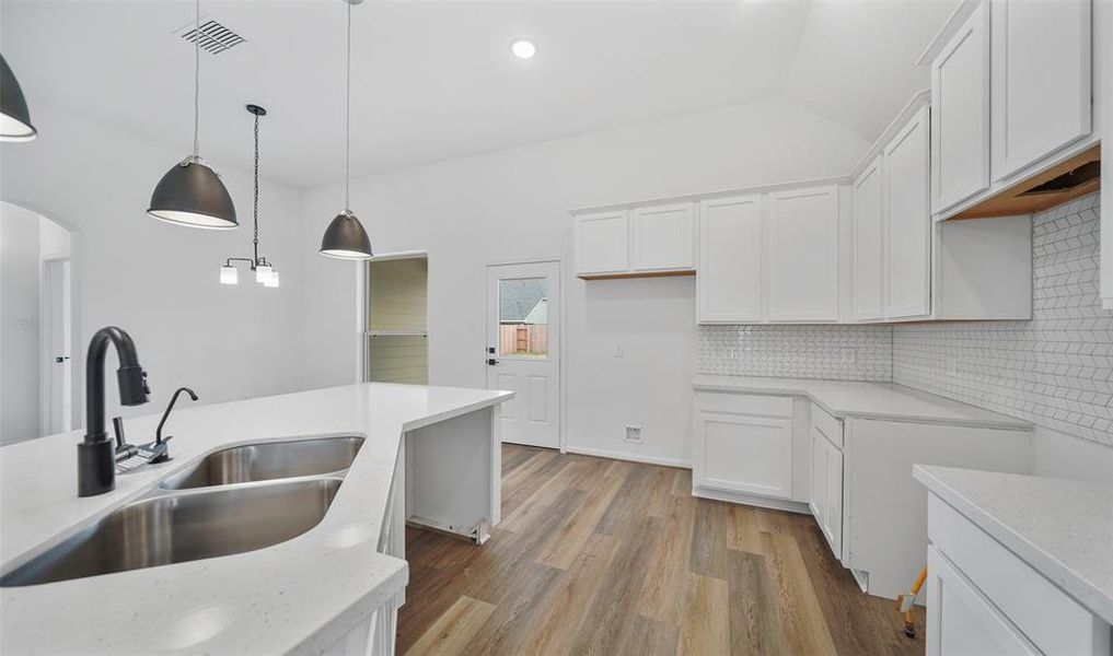 Elegant lighting in kitchen (*Photo not of actual home and used for illustration purposes only.)