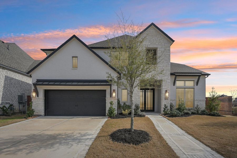 Front exterior of a new home in Elyson, Katy, TX, highlighting curb appeal (Image 2).