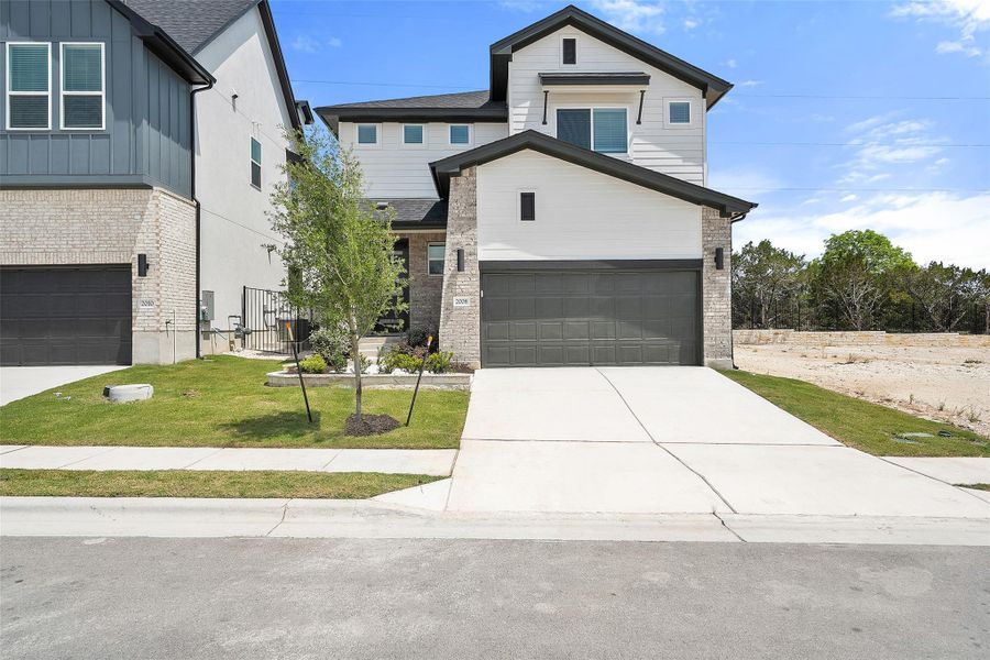 Front exterior of a new home in Foxfield, Austin, TX, highlighting curb appeal (Image 2). Front exterior of a new home in Foxfield, Austin, TX, highlighting curb appeal (Image 2).