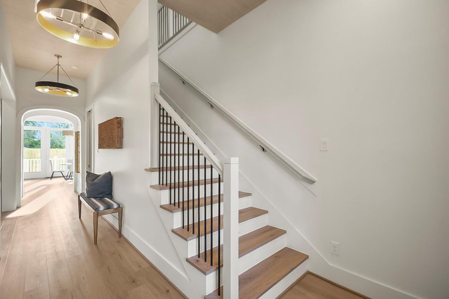 Step into a bright and inviting foyer that sets the tone for the home with elegant finishes, soaring ceilings, and a seamless flow into the main living spaces.