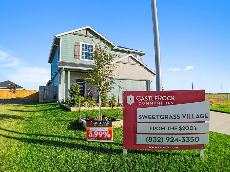 Front view of the CastleRock model home with signage highlighting Sweetgrass Village and the builder’s available floor plans—an inviting community built for comfort and connection. Front view of the CastleRock model home with signage highlighting Sweetgrass Village and the builder’s available floor plans—an inviting community built for comfort and connection.