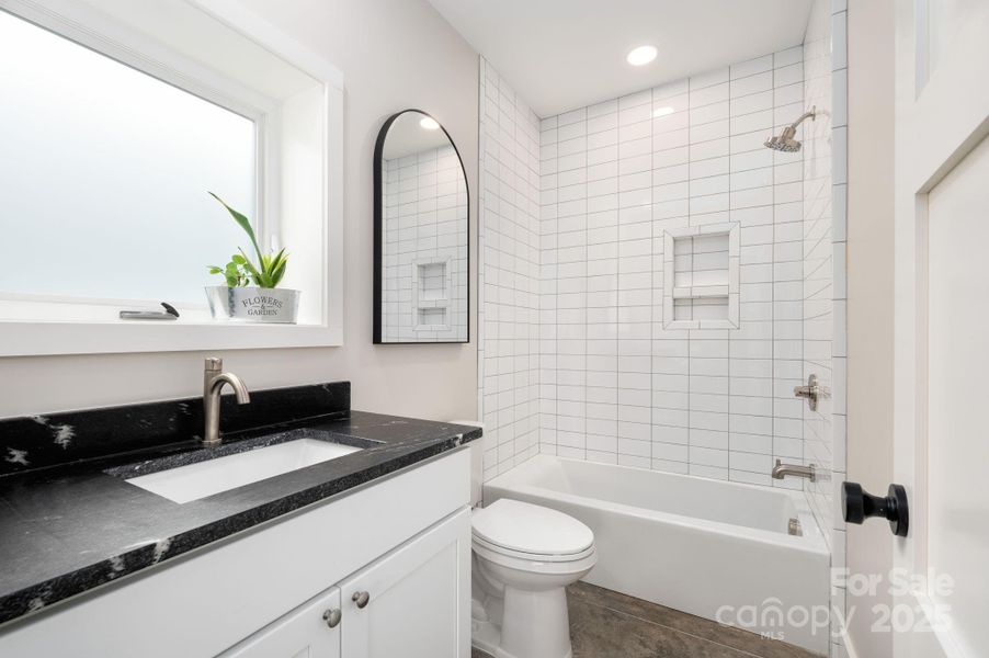 Full Bath with Leathered Granite Counter and Tiled Shower + Tub