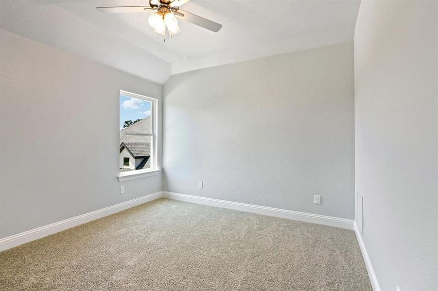 Spare room featuring carpet floors and ceiling fan