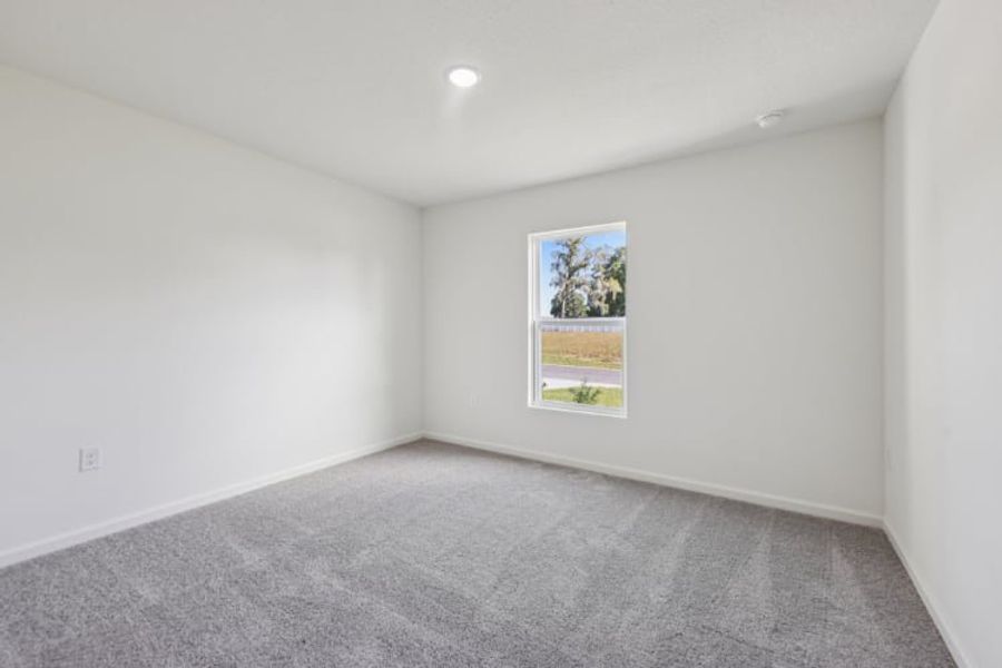 A room with a carpet and a painting on the wall.
