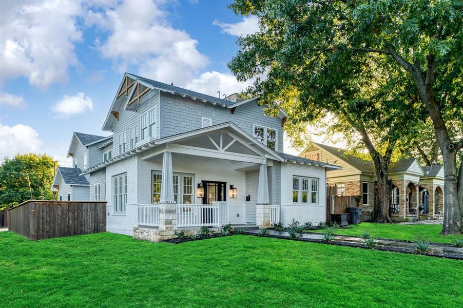 View of front of home with a porch and a front yard