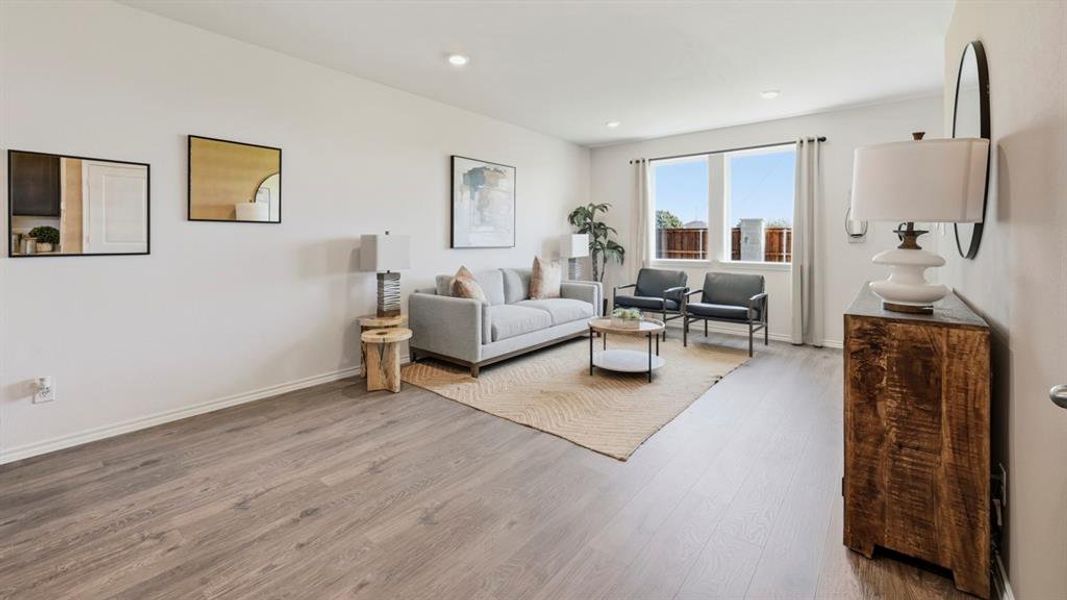 Living room with wood finished floors and recessed lighting