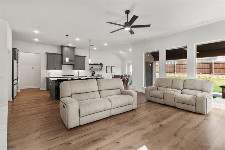 Living room with light wood-style flooring, recessed lighting, and ceiling fan