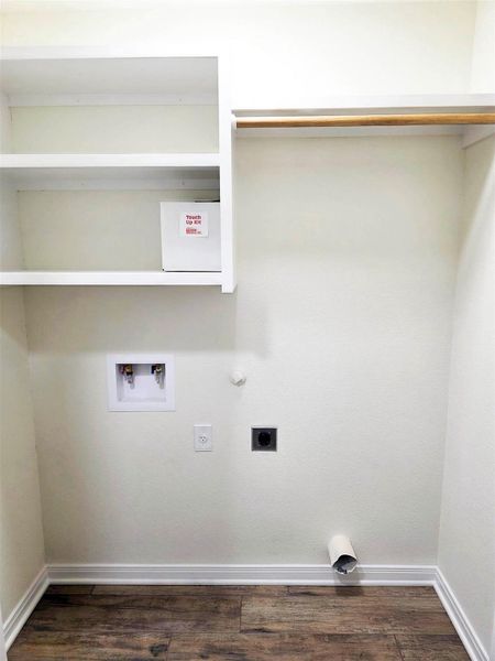 Washroom with dark wood finished floors, hookup for an electric dryer, washer hookup, and hookup for a gas dryer