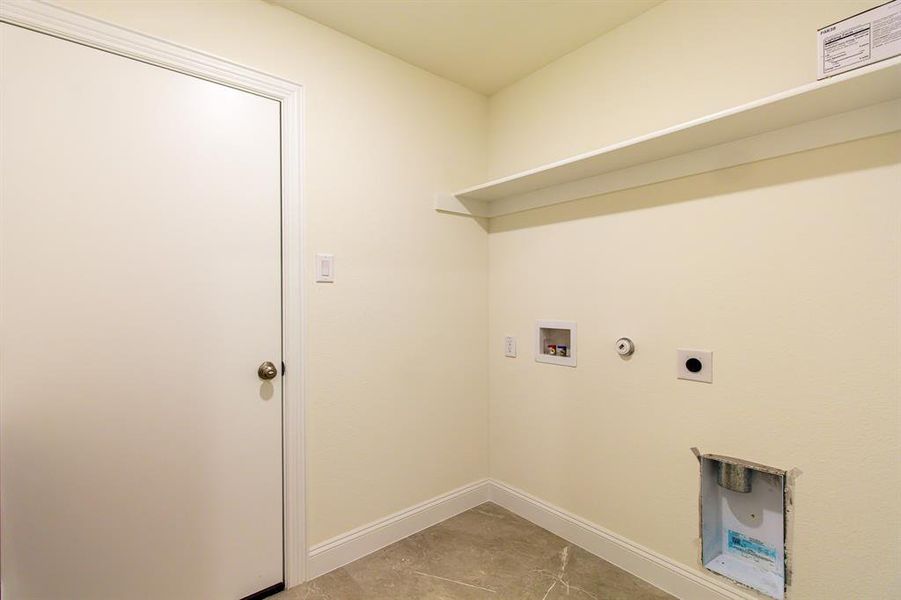 Laundry area with hookup for a washing machine, hookup for an electric dryer, and gas dryer hookup Laundry area with hookup for a washing machine, hookup for an electric dryer, and gas dryer hookup