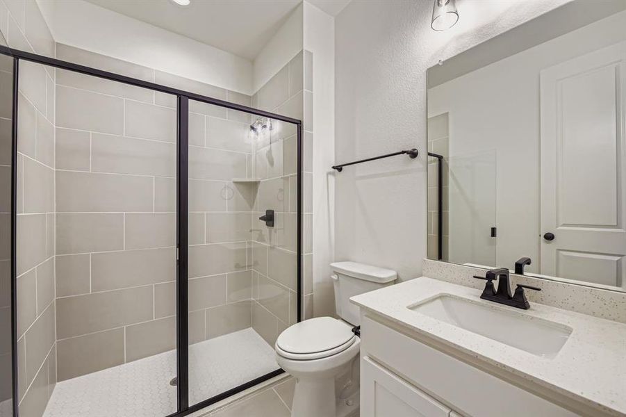 Full bathroom featuring vanity, a stall shower, and tile patterned flooring