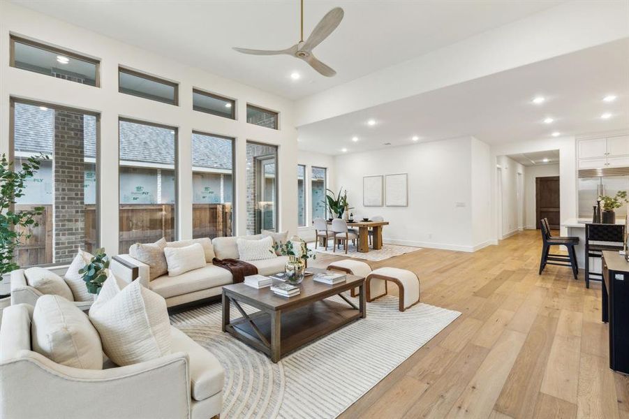 Living room featuring ceiling fan and light wood-type flooring