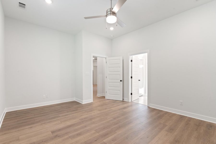 Recessed lighting, wood-finish flooring, ceiling fan, white interior doors, and crisp white walls