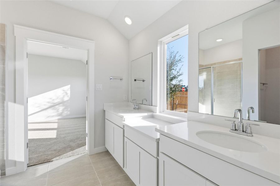 Full bathroom with light tile patterned floors, a stall shower, two vanities, light colored carpet, and recessed lighting