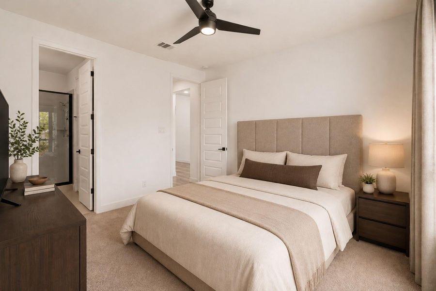 This downstairs secondary bedroom is complete with natural light, plush carpet, soft finishes, and a warm, inviting feel. *This photo has been virtually staged