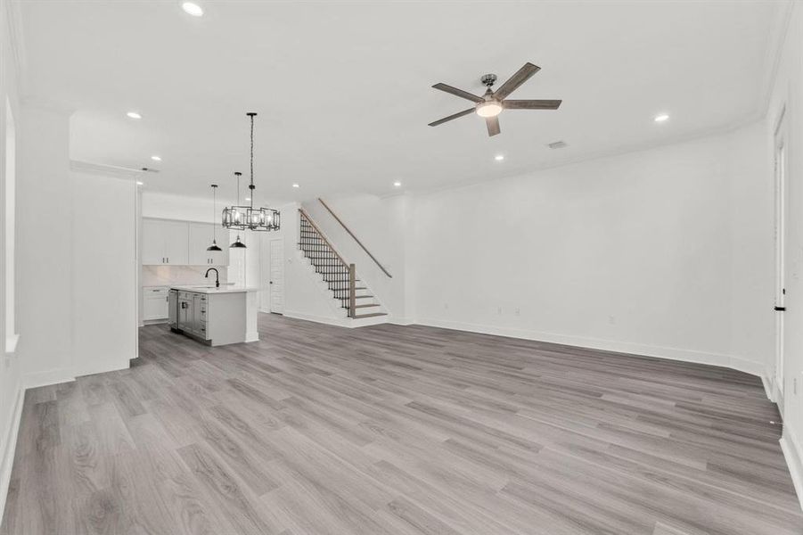 A different perspective of the main floor living area highlights the stunning staircase leading to the second floor.