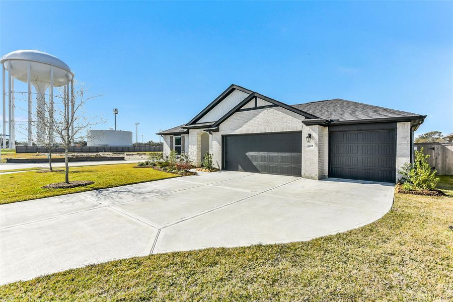 Front exterior of a new home in Sunrise Cove, Texas City, TX, highlighting curb appeal (Image 23).