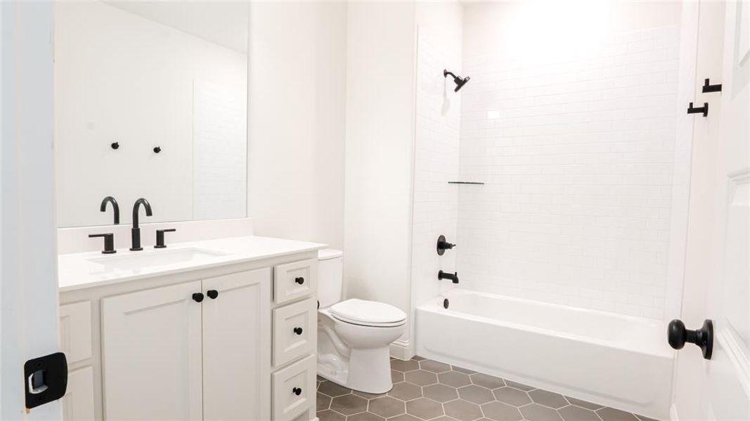 Full bath with vanity, washtub / shower combination, and tile patterned flooring Full bath with vanity, washtub / shower combination, and tile patterned flooring