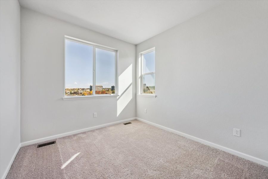 A room with a window and a carpet. A room with a window and a carpet.