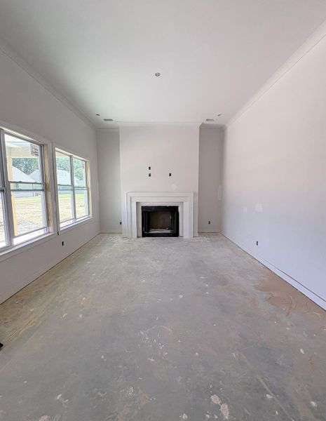 Recessed lighting, crown molding, multiple windows, fireplace with mantel, and high ceilings