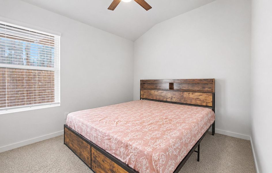 The spacious secondary bedroom provides flexibility for guests, a home office, or workout space. The spacious secondary bedroom provides flexibility for guests, a home office, or workout space.