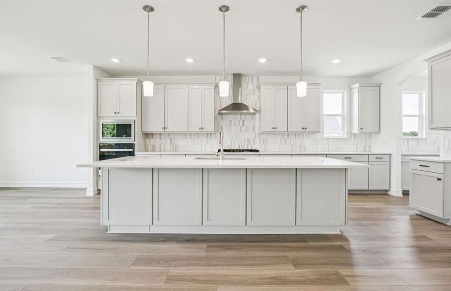 Bright kitchen with an expansive center island perfect for gatherings *Real home pictured Bright kitchen with an expansive center island perfect for gatherings *Real home pictured