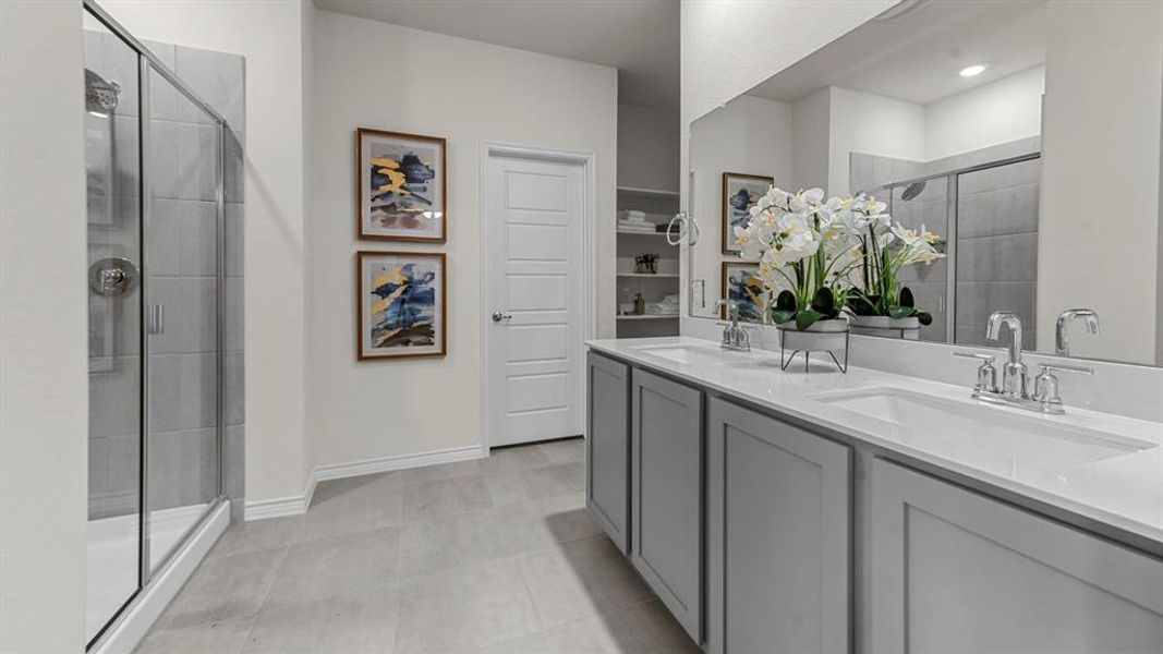 Bathroom featuring a double vanity with light gray cabinetry and white countertops