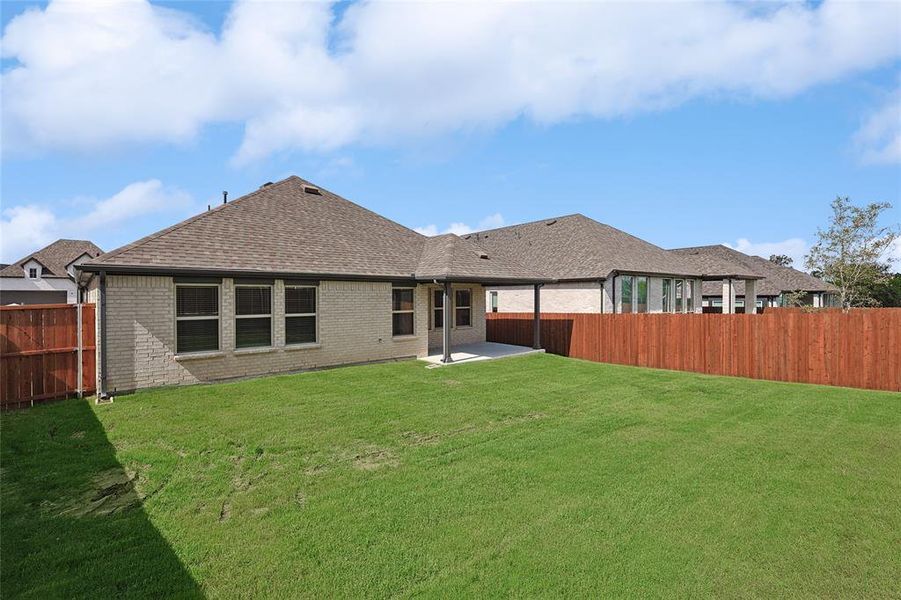 Back of house featuring a patio and a lawn