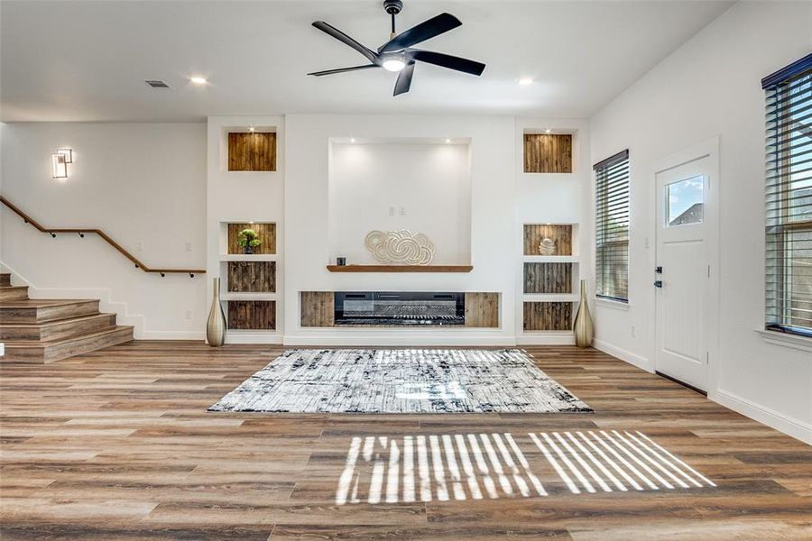 Entrance foyer featuring wood finished floors, ceiling fan, stairway, and recessed lighting