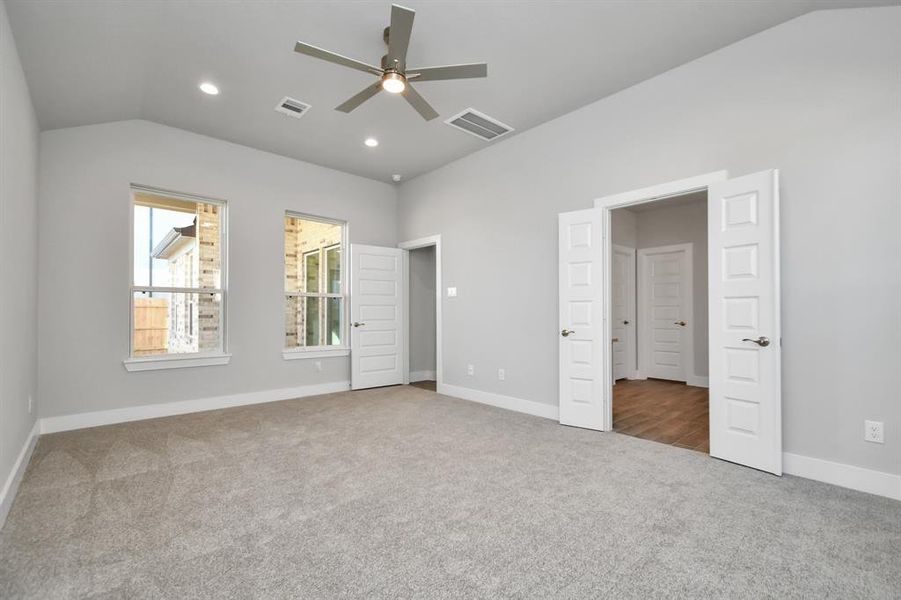 Come and unwind after a long day in this magnificent primary suite! This spacious room features plush carpet, warm paint, high ceilings and large windows with privacy blinds. Sample photo of completed home with similar plan. As built color and selections will vary.