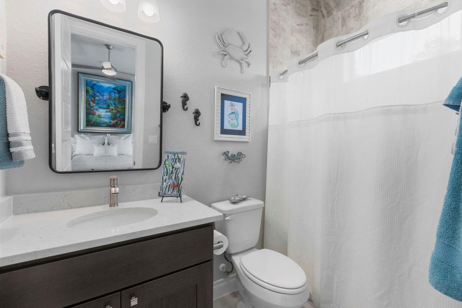 A well-appointed lavatory boasts a pristine vanity with ample storage, perfect for refreshing mornings.