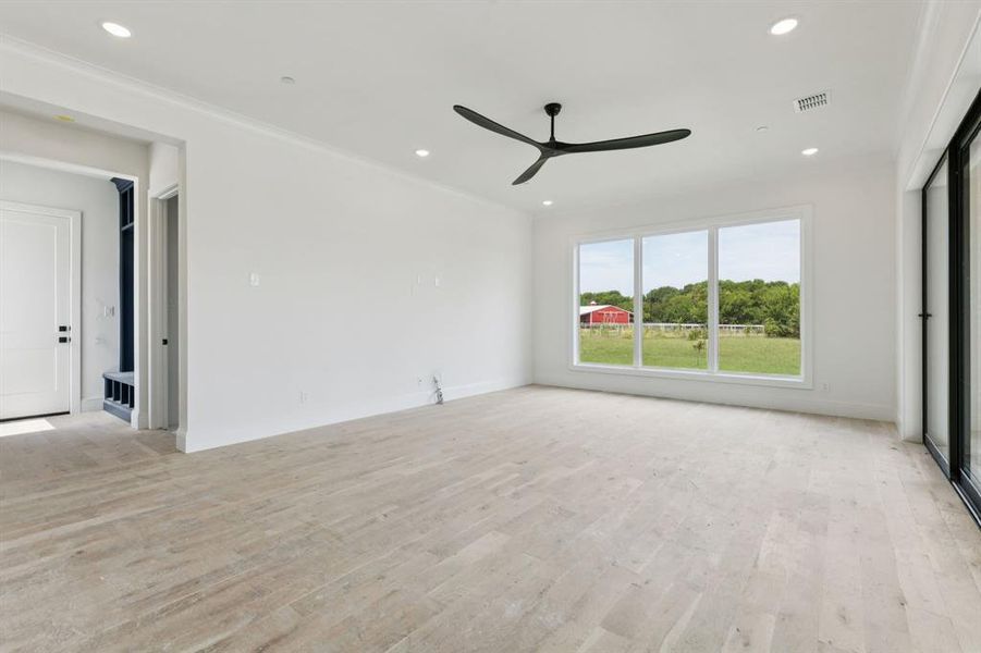 The family room features a gorgeous floor to ceiling glass wall that completely opens, creating a seamless transition to outdoor living.