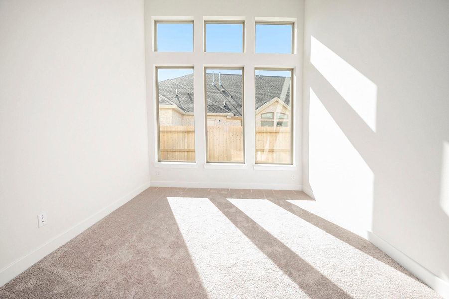 The secondary bathroom features a modern walk-in shower with elegant tile finishes and refined fixtures. Designed for both style and convenience, this beautifully appointed space offers a perfect blend of luxury and practicality for guests or family members.