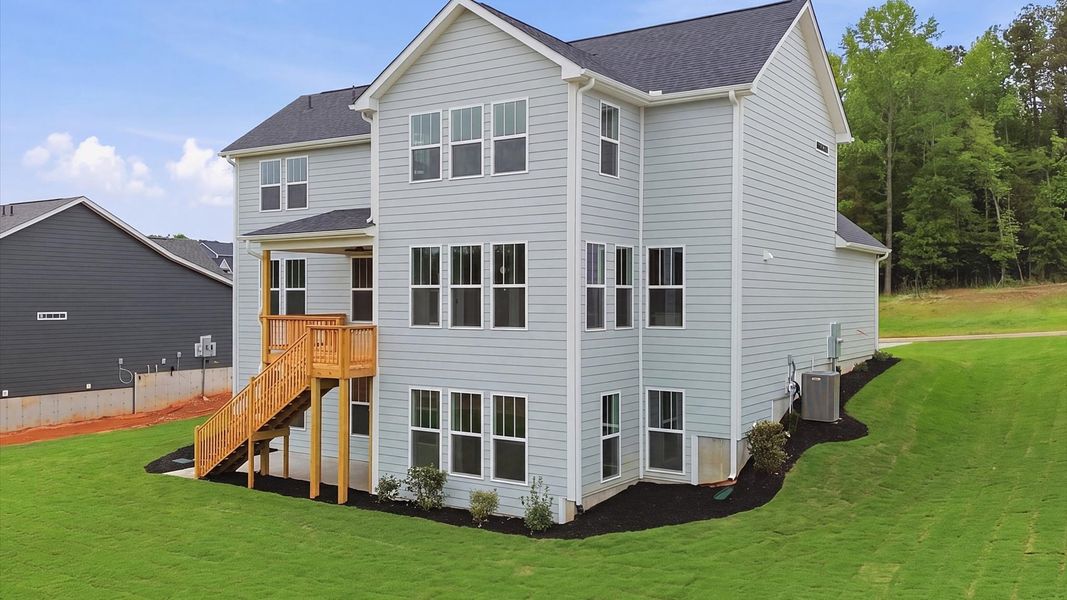 Highly functional rear covered porch and deck adds memorable living space to this elegant home in Woodruff, SC
