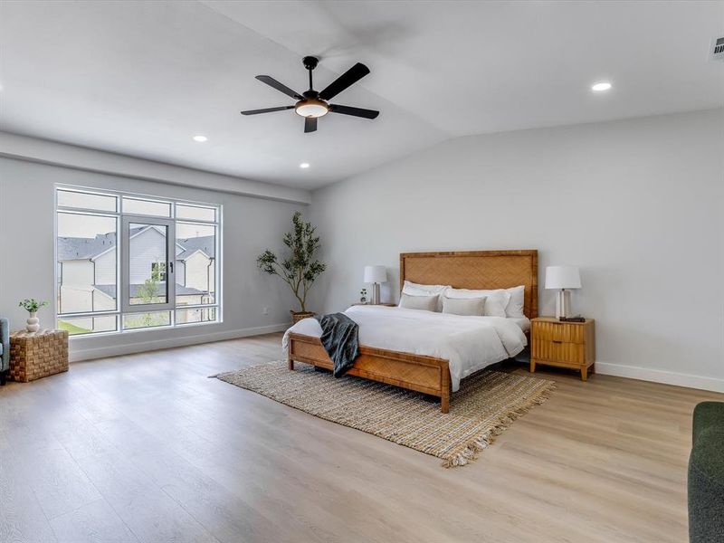 Massive upstairs primary bedroom! Spacious room with light wood-finish flooring, recessed lighting, and a modern ceiling fan Massive upstairs primary bedroom! Spacious room with light wood-finish flooring, recessed lighting, and a modern ceiling fan