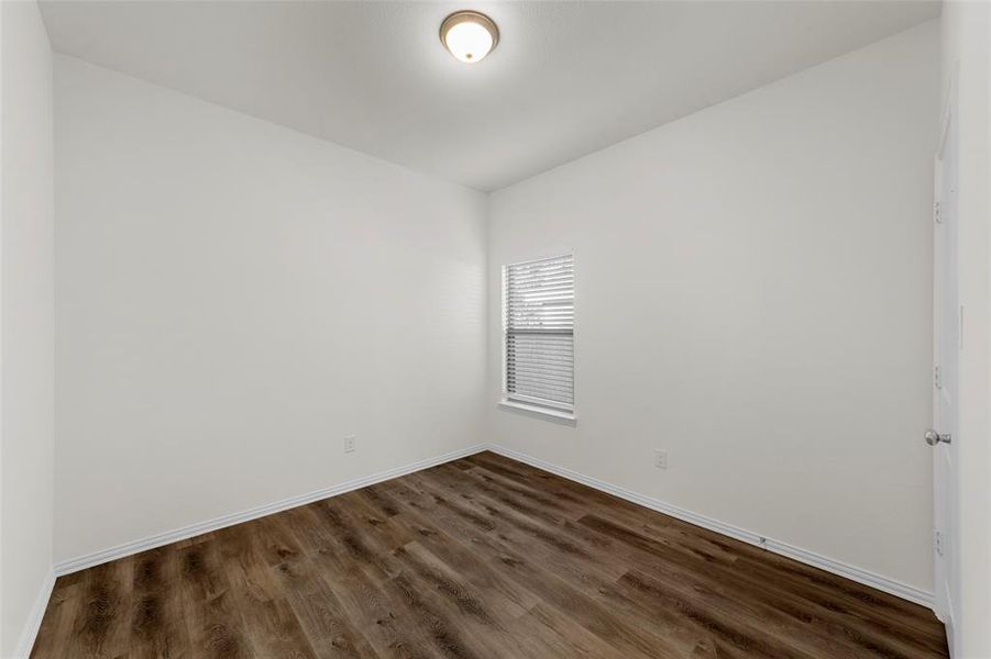 Spare room featuring dark hardwood / wood-style flooring