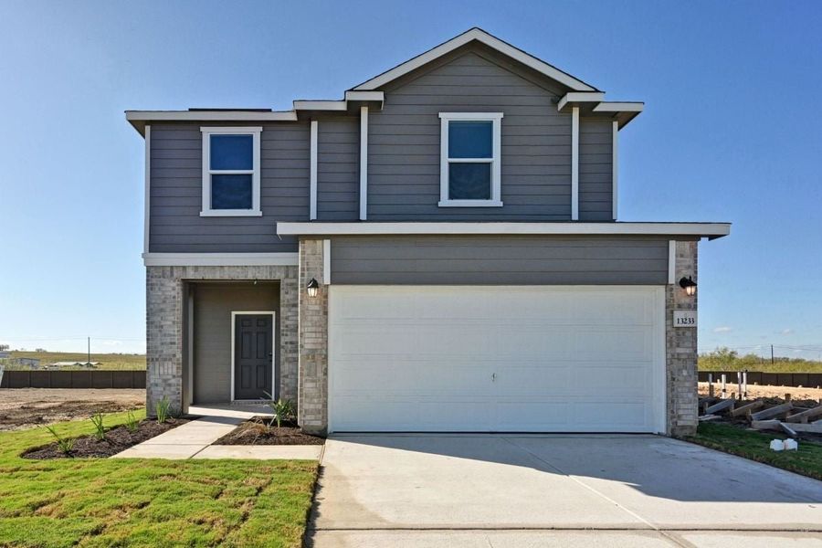 Front exterior of a new home in Stoney Chase, Del Valle, TX, highlighting curb appeal (Image 2). Front exterior of a new home in Stoney Chase, Del Valle, TX, highlighting curb appeal (Image 2).