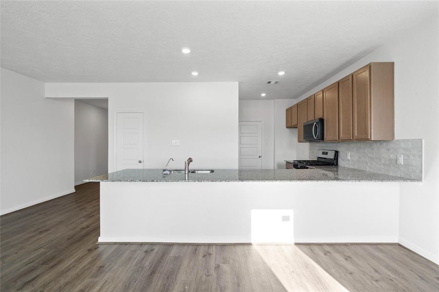 This spacious kitchen has it all—ample storage, generous counter space, and a layout that truly makes it the heart of the home.