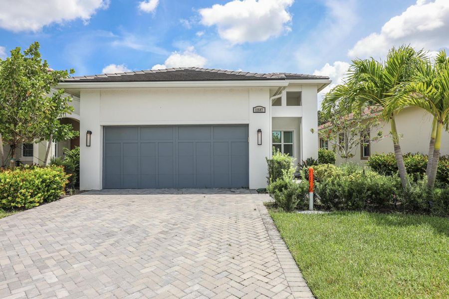 Front exterior of a new home in PGA Village Verano, Port St. Lucie, FL, highlighting curb appeal (Image 19).