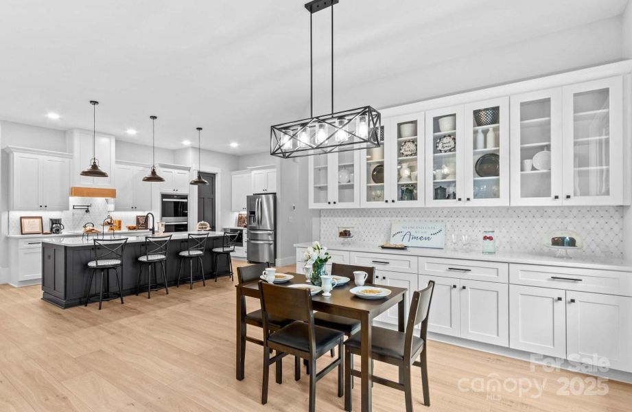 Gourmet Kitchen with double ovens, pot filler, quartz counters, ten foot island & Buffet serving area.