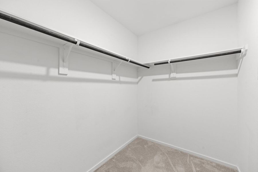 Generously sized walk-in closet offers wraparound hanging rods and shelving for organized wardrobe storage. Generously sized walk-in closet offers wraparound hanging rods and shelving for organized wardrobe storage.