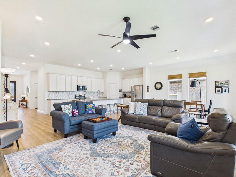 The living room flows seamlessly into the kitchen and dining area, creating a bright, open space filled with natural light—perfect for everyday living and entertaining.
