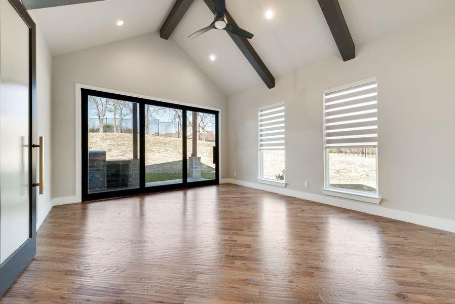 Unfurnished room with hardwood / wood-style flooring, ceiling fan, and a healthy amount of sunlight