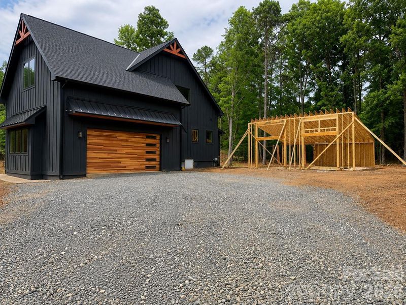 Oversized attached 3-car tandem garage with 15ft ceiling. Additional detached secondary two-car garage and/or workshop is under construction.