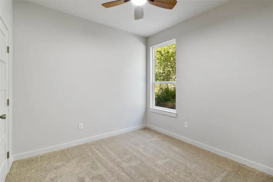Carpeted spare room with baseboards and ceiling fan Carpeted spare room with baseboards and ceiling fan
