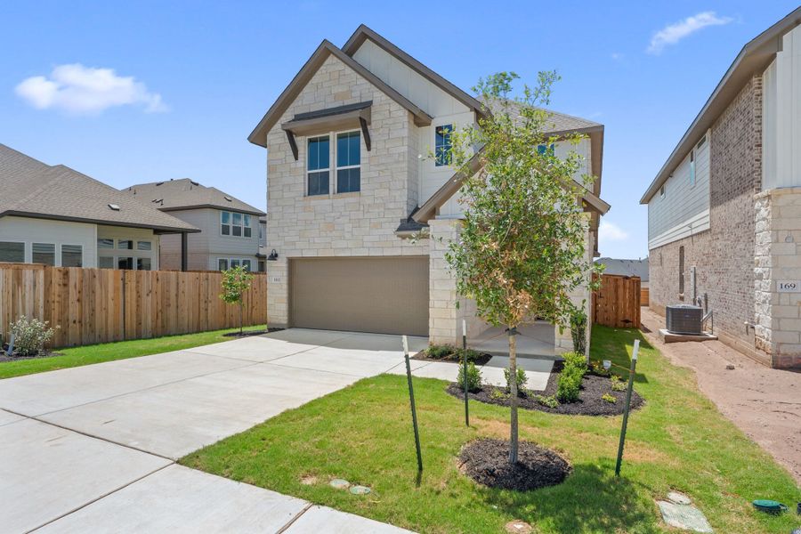 Front exterior of a new home in Heritage, Dripping Springs, TX, highlighting curb appeal (Image 2). Front exterior of a new home in Heritage, Dripping Springs, TX, highlighting curb appeal (Image 2).