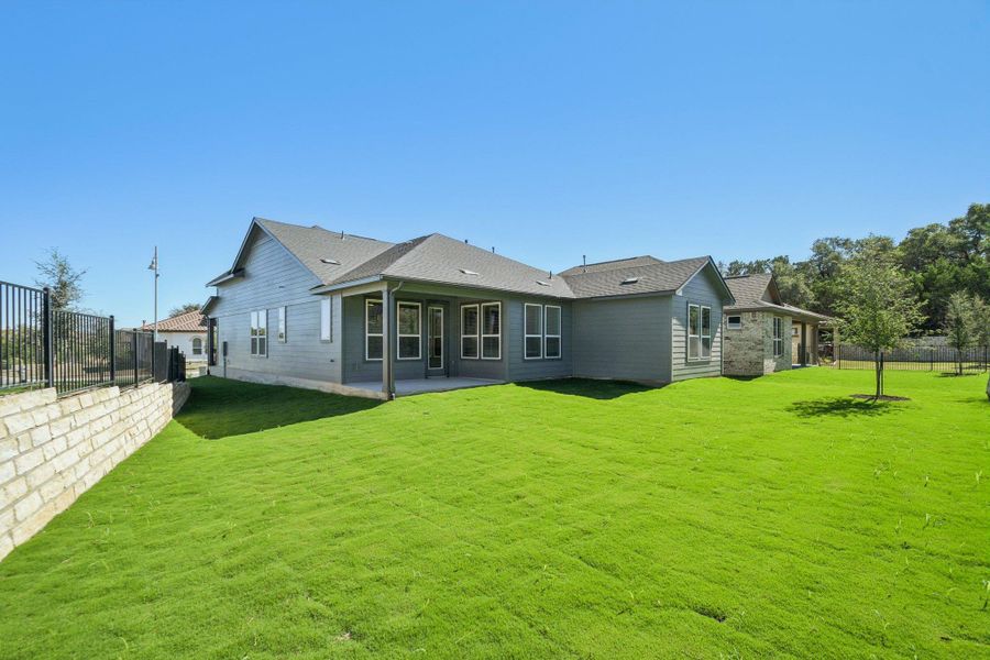 Rear view of property with a fenced backyard, a patio area, and a shingled roof Rear view of property with a fenced backyard, a patio area, and a shingled roof
