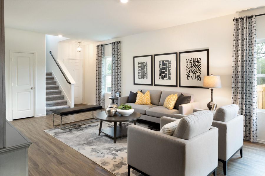 Living area featuring stairway and wood finished floors