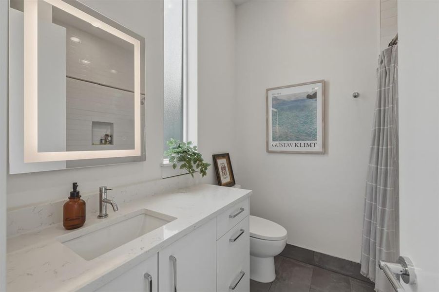 Full bath featuring vanity and curtained shower