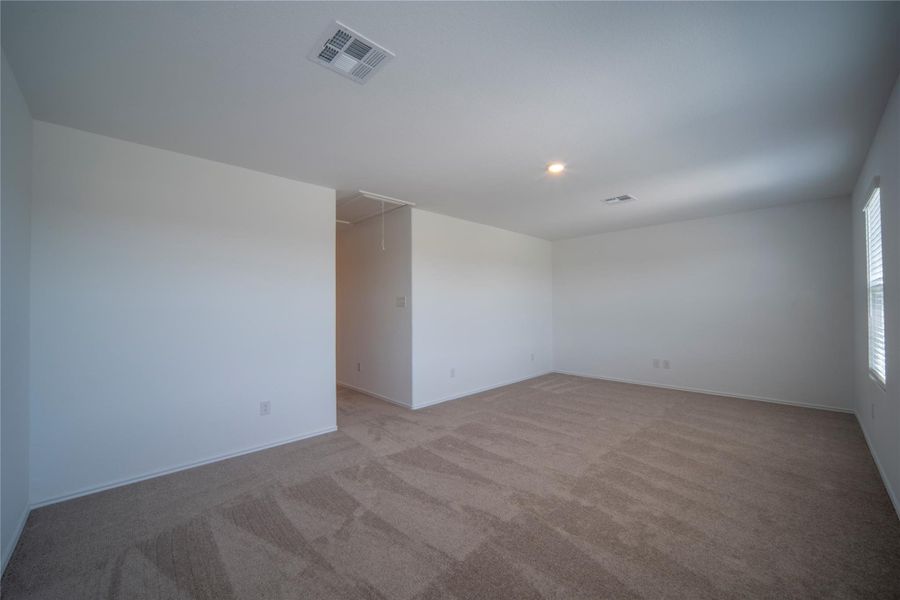 Empty room with attic access, carpet, and recessed lighting