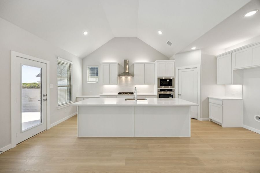 Kitchen in the Wimbledon home plan by Trophy Signature Homes – REPRESENTATIVE PHOTO